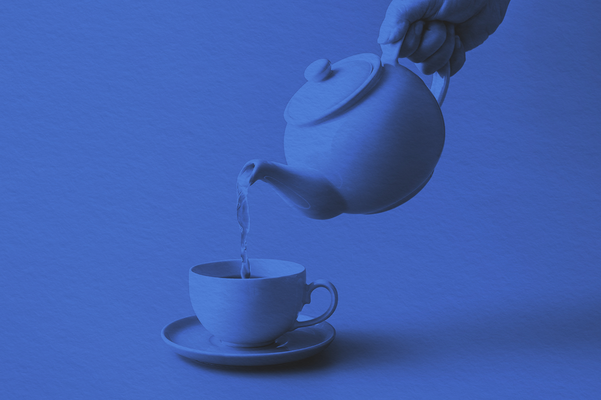 Pouring tea from a pot into a cup