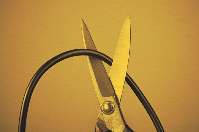 Scissors cutting a computer wire