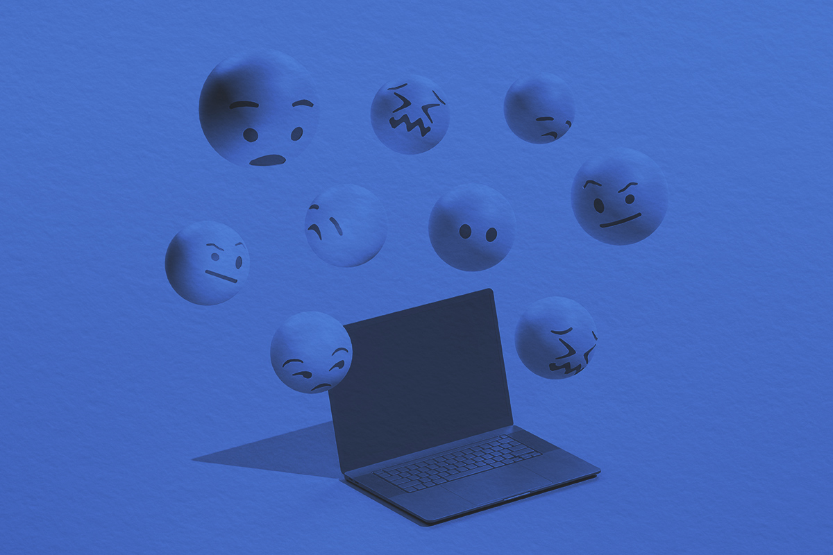 Emojis hovering over a laptop