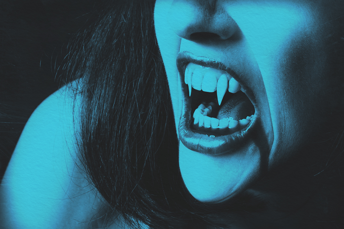 close up of a female vampire's mouth with blood running out