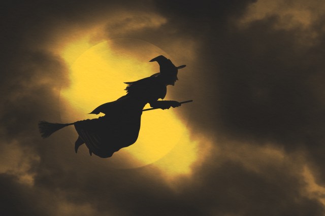 Witch flying on broom during witching hour