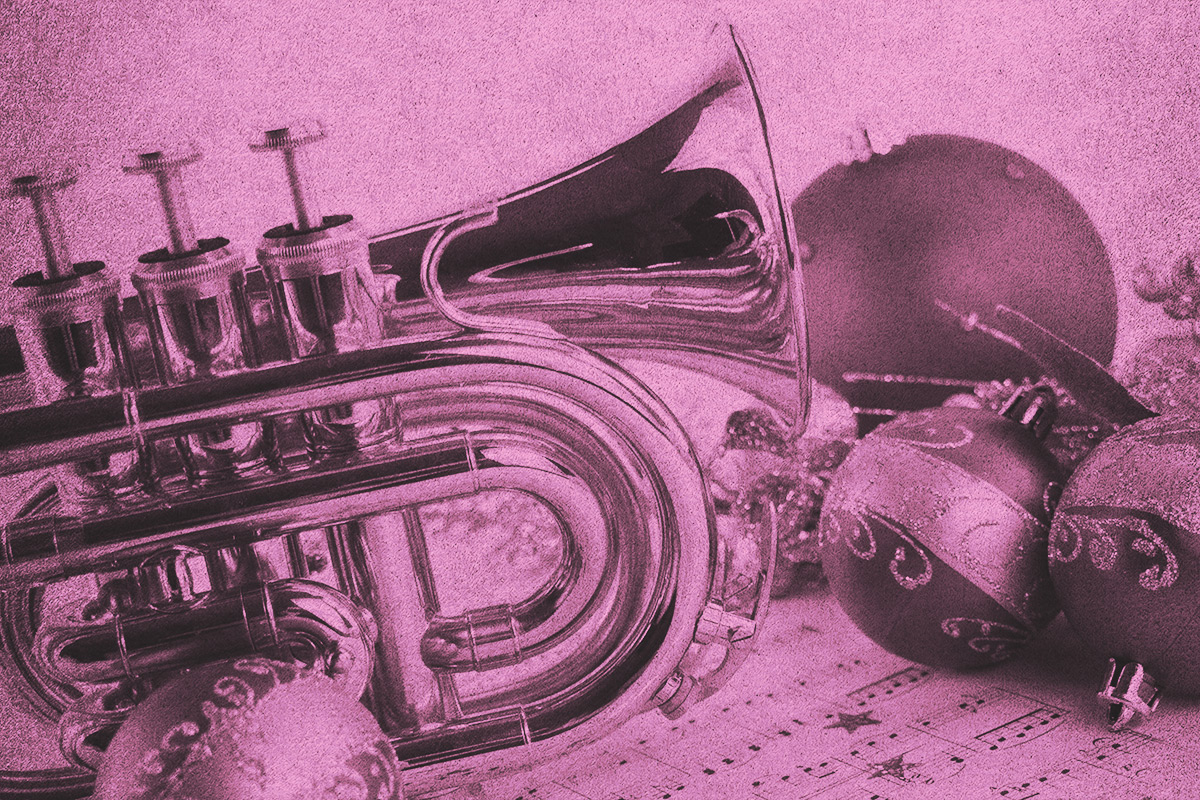 close-up of a trumpet surrounded by holiday music and ornaments