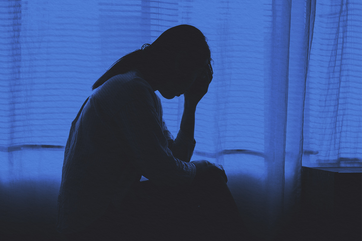 Silhouette photo of young woman feeling upset, sad, or disappoint