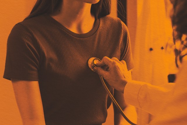 Doctor checking a patients breathing rhythm