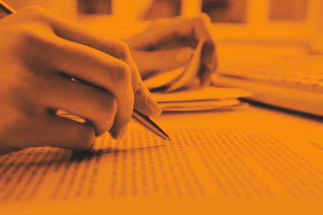 Close-up of human hands doing paperwork
