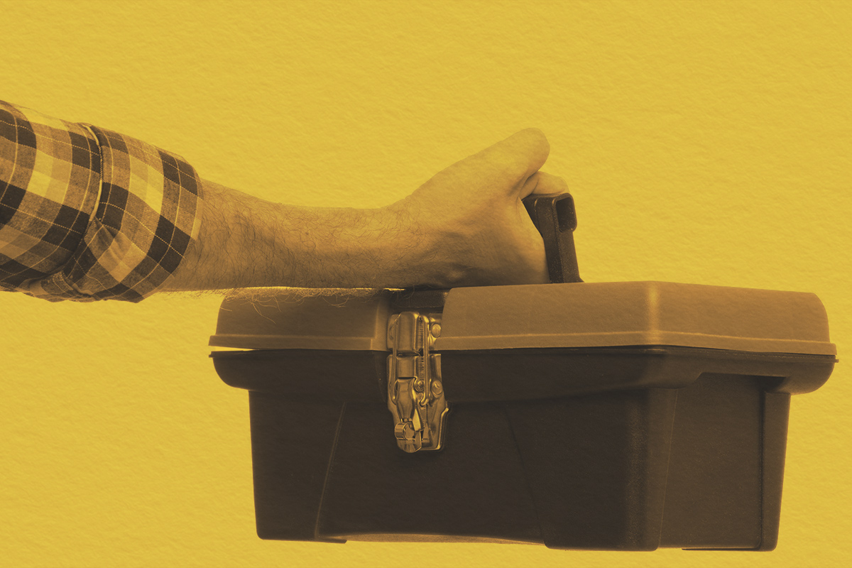 Close-up of a person holding a tool kit box