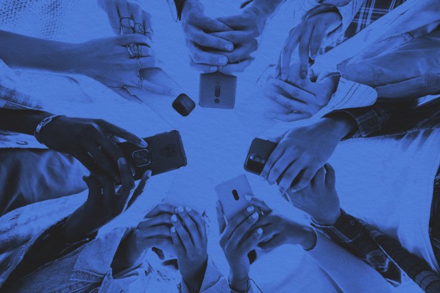 Low angle view of phones covering up the faces of gen z students