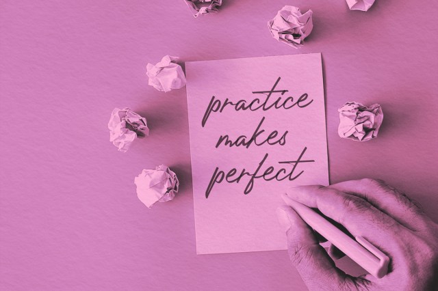 crumpled paper balls and a paper with text PRACTICE MAKES PERFECT