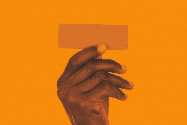 Hand holding punctuation mark hyphen