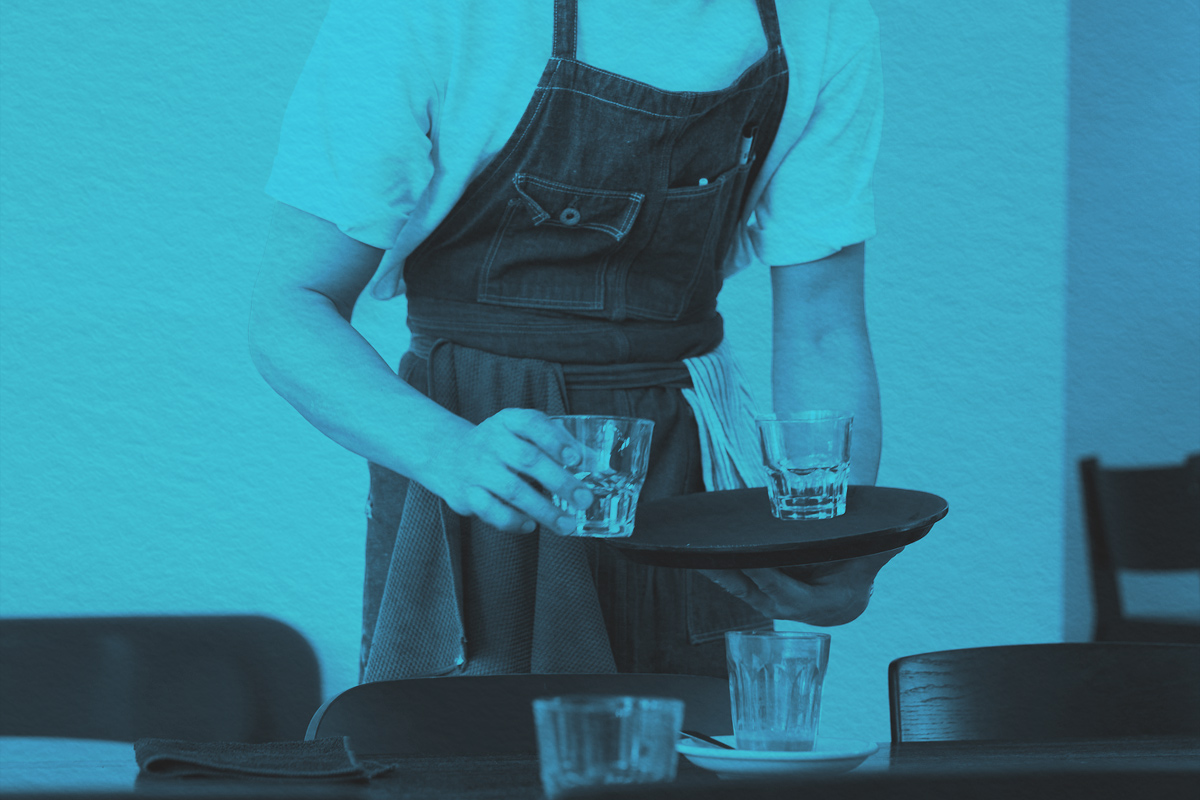 Waiter cleaning a restaurant table