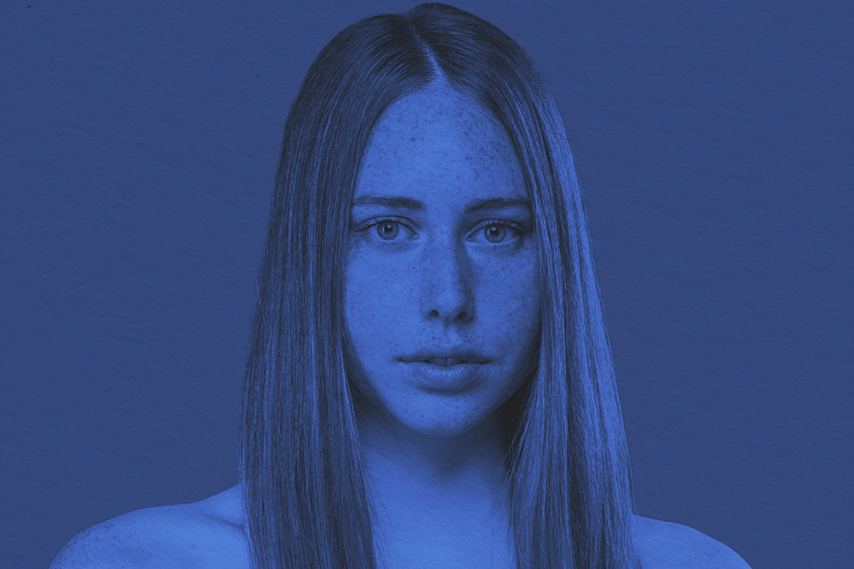 Studio portrait of young woman with ginger hair